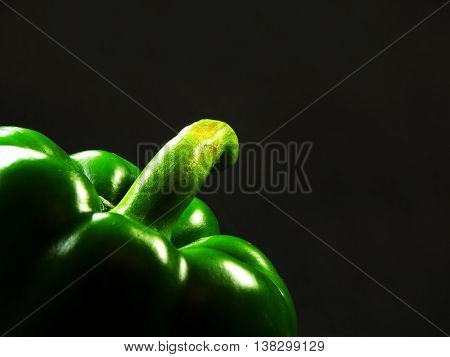 elegant green peppers on a black background