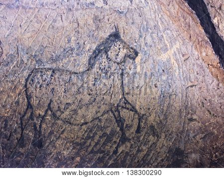 Old Cave. Black Paint Of Horses On Sandstone Wall,