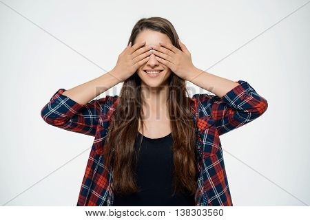 Dissapointed young girl covering her eyes. Over white background