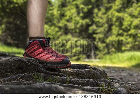 Woman is firmly standing on a rough terrain.