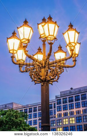 Old-fashioned city street lamp in the nigt. Gendarmenmarkt in Berlin, Germany