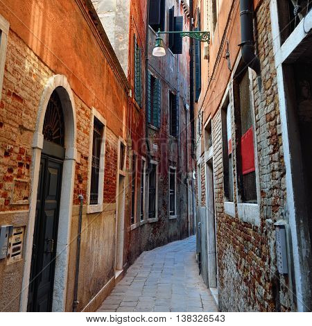 Narrow medieval street in historic part of Venice Italy