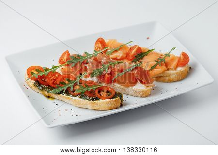 sandwiches with greenary, tomatoes and meat on a white background