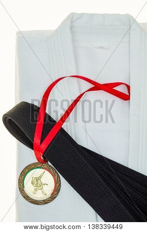 Black belt in martial arts and a part of judo uniform and medal