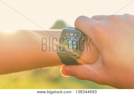 MIADEL, BELARUS - June 16, 2016: Someone using app on Apple Watch outside, multiple apps view