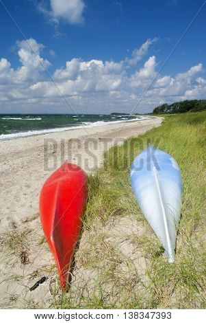 Red and blue Canoe on the beach near the Danish village Saltofte on the isle of Funen