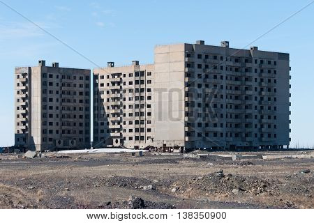 Derelict high-rise building in Norilsk. House on pile foundation, built on permafrost.