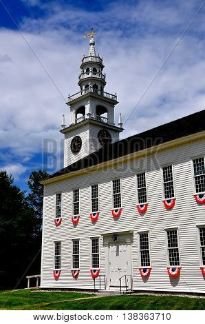 Jaffrey Center New Hampshire: Red white and blue patriotic bunting hangs from the windows of the austere 1775 Original Meeting House church with its elegant steeple and bell tower