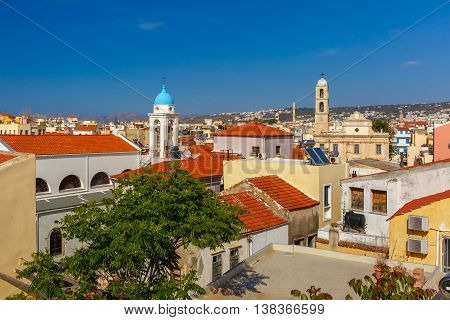 The medieval city with Orthodox cathedral Trimartiry, aerial view from Schiavo Bastion in the sunny morning, Crete, Greece