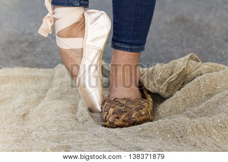 Feet girl in Ballet shoes and Bast shoe on canvas on the road