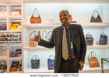 NEW YORK - APRIL 06, 2016: indoor portrait of seller in Michael Kors store at JFK Airport. Michael Kors Holdings is an American luxury fashion company established in 1981 by designer Michael Kors.