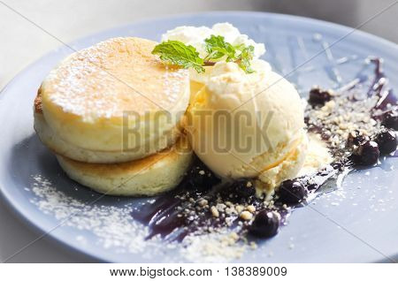 pancake and vanilla ice cream with blueberry sauce dish