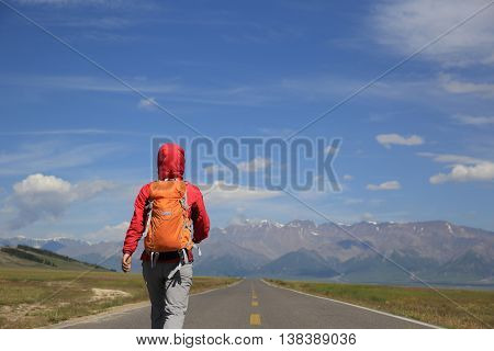 young woman hiker hiking at beautiful mountain trail