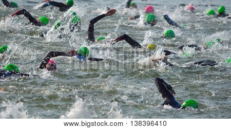 Grafham, Cambridgeshire, England - May 22, 2016:  Competitors swimming out into open water at the beginning of Triathlon.