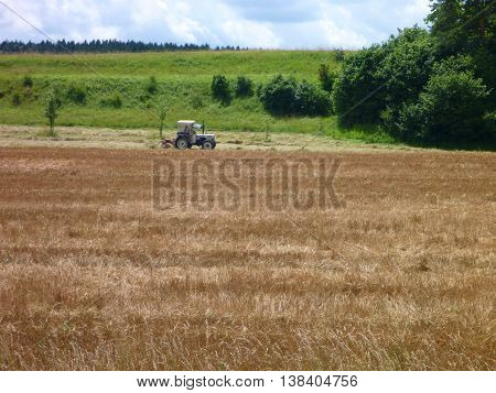 Tractor Harwesting Crops On A Field