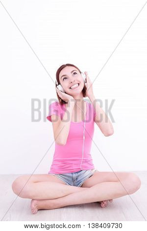 young womn sit listen music and smile caucasian