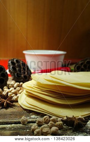 Colorful Indian food - papadum chickpea gram flour and spices on textured wooden table top