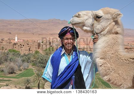 Tinerhir, Morocco - march 22, 2012: Young man with Arab and his camel clothing , on the outskirts of Tinerhir