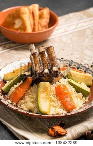Traditional couscous dish with lamb ribs and vegetables. Still life. The image is describing moroccan cuisine