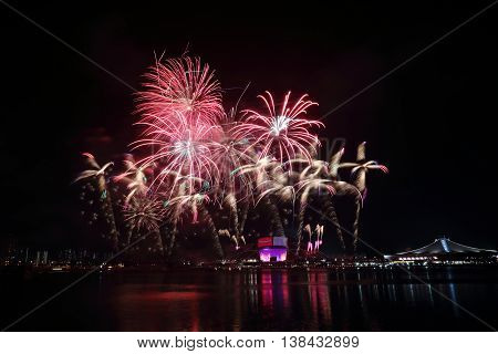 Fireworks celebrating Singapore's National Day across Kallang River