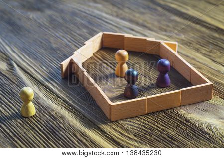 The concept of a mortgage buying a home. The man in the house and people without a home.