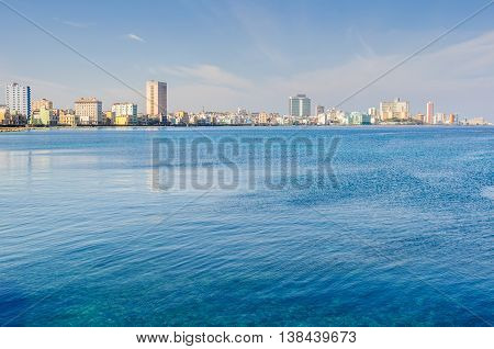 HAVANA, CUBA - MARCH 17, 2016: The skyline of the Vedado neighborhood with its skyscraper hotels on the shore in Havana the capital of Cuba