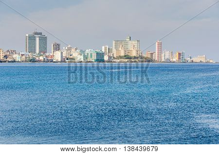 HAVANA, CUBA - MARCH 17, 2016: The skyline of the Vedado neighborhood with its skyscraper hotels on the shore in Havana the capital of Cuba