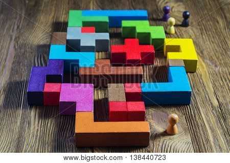 The man in the maze. The concept of a business strategy, analytics, search for solutions, the search output. Labyrinth of colorful wooden blocks, tetris.