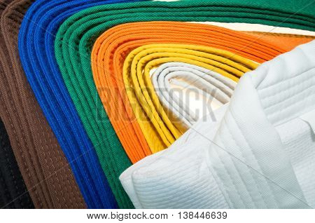 colored belts in martial arts and a part of judo uniform for an almost abstract background