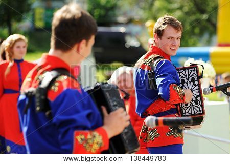 Orel Russia - July 08 2016: Russian Valentine Day - Petr and Fevronia. Men in Russian outfits playing Russian accordion selective focus