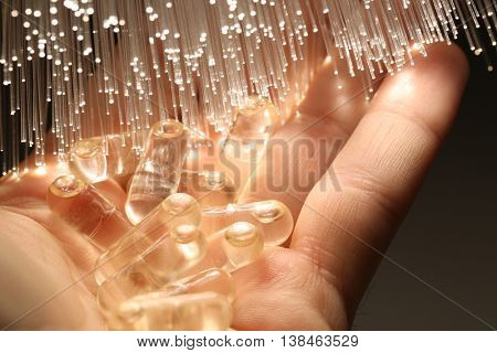 liquid capsule on fiber optical technology background