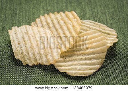 Tasty Golden rippled potato chips close up