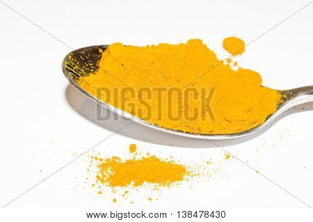 Turmeric heart health yellow spice powder on white background