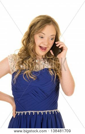 a woman with down syndrome in her fancy blue dress talking and laughing on her phone.