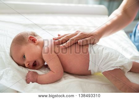 Close-up Of A Mother Patting On Cute Little Baby's Back