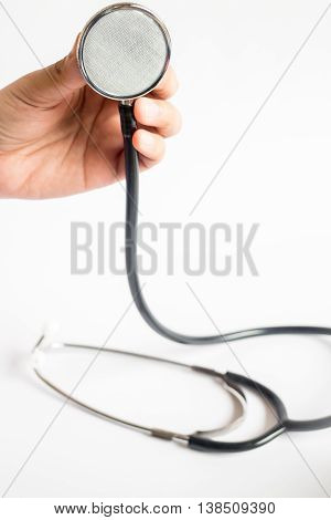 Hand on stethoscope on white background stock photo