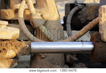 hydraulic hoses on a piston against the hydraulic system in the bulldozer