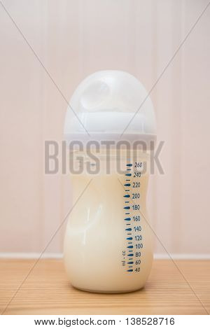 baby bottle of powdered milk at home close up