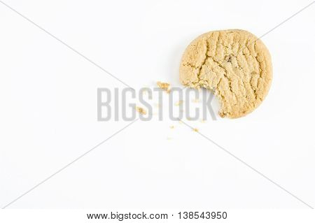 Stem ginger cookie with a bite out of it on a white background