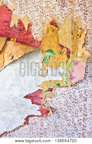 Old grunge tattered wallpaper in a ruined house