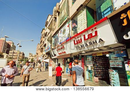 TEHRAN, IRAN - OCTOBER 6, 2014: Rushing customers walking past electronic stores on October 6 2014. About 30 perc. of Iran's public-sector workforce and 45 perc. of industrial firms are located in Tehran