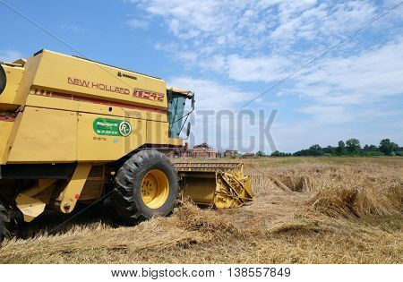 TRNOVEC, CROATIA - JULY 09, 2016: Combine harvester harvest ripe wheat on a farm in Trnovec, Croatia on July 09, 2016