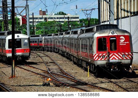 New Haven Connecticut - June 20 2013: A Metro-North MTA commuter train (right) approaching Union Station