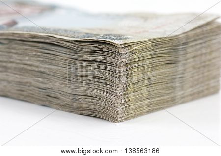 A stack of Bahraini Dinars on a white background