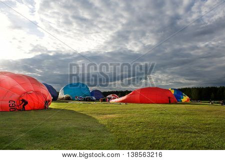 Hot air balloons preparing for the flight n nice sunset in July 9, 2016 in Birstonas, Lithuania. Hot air balloon preparing for flight