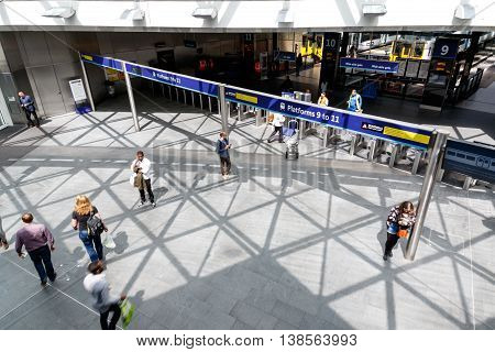 London UK - July 5 2016 - Travellers pass along platforms in Kings Cross train station