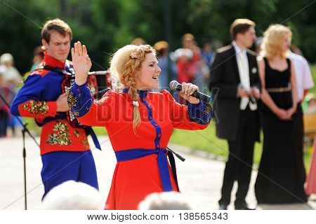Orel Russia - July 08 2016: Russian Valentine Day - Petr and Fevronia. Woman in red dress singing horizontal