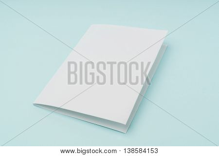 Bifold white template paper on blue background