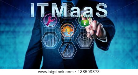 Enterprise executive is pressing ITMaaS on an interactive touch screen. Technology nomenclature and acronym for Information Technology Management as a Service. IT infrastructure concept. Close up.