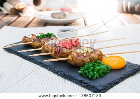 Tsukune - Japanese grilled chicken meatballs on a plate